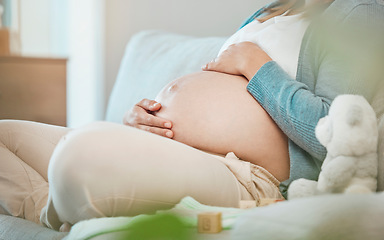 Image showing Pregnant, stomach and mother bond with her baby while resting during maternity at home. Tummy, belly and pregnancy with a mommy to be holding her abdomen and caring for her kid while relaxing