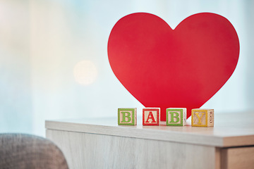 Image showing Heart, sign and baby toy announcement for a kid, child or newborn on a family home table. Love, care and announce or notification in wooden building blocks design for colourful news with a shape