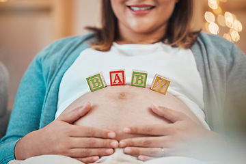 Image showing Pregnant woman, hands and baby letter blocks for maternity, love and care holding tummy for soothing at home. Happy female smile touching stomach in pregnancy, mother to be or support for motherhood