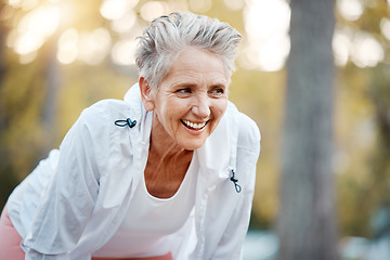 Image showing Fitness, running and park with a senior woman athlete outdoor in nature for exercise or cardio training. Tired, rest and workout with a mature female runner in a garden during summer for endurance