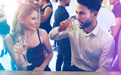 Image showing Party, man and woman talking and drinking on a date to celebrate new years eve with dancing. Dating, partying and a couple of friends chat while celebrating at the disco with alcohol drinks