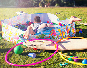 Image showing Drunk man, hungover and sleeping in a swimming pool with butt out while on vacation at a house party on lawn to celebrate with drinks, alcohol or wine. Crazy male lying outdoor after new years