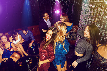 Image showing Night club, party and friends dance in disco for celebration, new years or VIP social event of music, drinks and entertainment. Group of people, dancing and crowd celebrate together in dark nightclub