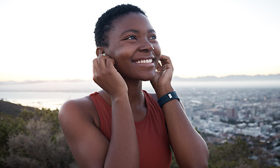 Image showing Headphones, runner or black woman in nature for fitness training, running workout or cardio exercise in Cape Town. Music, podcast or happy sports athlete thinking of goals or target streaming radio