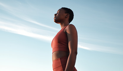 Image showing Fitness, meditation and woman on blue sky to breathe fresh air, freedom and energy to exercise, workout and do yoga or cardio training outdoor in nature. Black female take breath for mental health