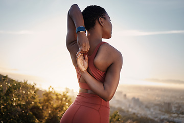 Image showing Fitness, black woman and stretching arm on mountain in Cape Town for muscle wellness, healthy goals and energy. Athlete, warm up and mobility for workout, sports exercise and start training in nature