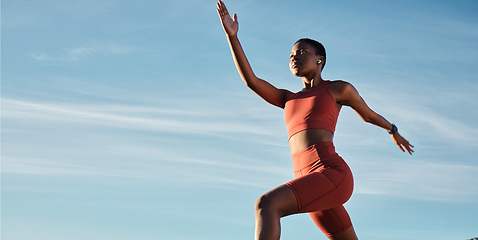 Image showing Black woman, music earphones or running in workout, training or exercise for healthcare, marathon or cardiovascular wellness. Low angle, sports or fitness runner on blue sky background with radio