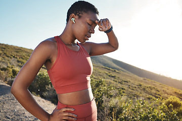 Image showing Fitness, music and tired with a sports black woman running in the mountain for cardio or endurance exercise. Workout, exhausted and sweat with a young female runner or athlete taking a break