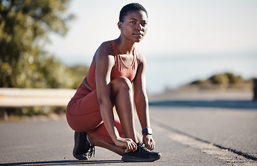 Image showing Lace shoes, fitness and black woman woman on street for workout, running and wellness in Nigeria. Runner, sports athlete and girl tie sneakers for exercise, focus mindset and vision, health and goals