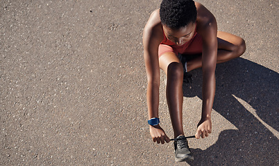 Image showing Black woman, fitness and shoes in preparation for running, exercise or cardio workout on mockup. African American woman runner tying shoe lace getting ready for race, run or sports above on mock up