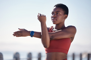 Image showing Black woman, fitness and stretching arms for exercise, workout or cardio training in the outdoors. African American woman in warm up arm stretch for healthy exercising, sports or activity in nature