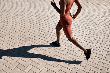 Image showing Running, runner and woman with fitness in city, training for marathon and exercise with cardio workout in Seattle. Urban, run outdoor with health and wellness, active life and athlete shadow in sport