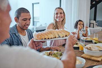 Image showing Interracial family dinner, food and happiness with bonding, bread and celebration for thanksgiving. Happy family, lunch or brunch in family home for christmas, party or giving for love in Los Angeles