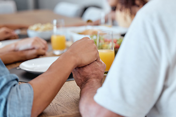 Image showing Family, holding hands and praying for Thanksgiving dinner, New Year lunch or Christmas meal in religion routine, tradition and worship. Zoom, bonding man and woman praying for food in house or home