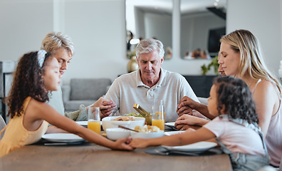 Image showing Family, food and holding hands for prayer together at dining room table, worship support and relax quality time. Dinner, big family and Christian religion, praying and grace for supper buffet in home