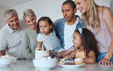 Image showing Big family, birthday cake and blowing candles for a wish at home with parents, grandparents and children together for a celebration. Men, women and kids in UK house to celebrate at party for a girl