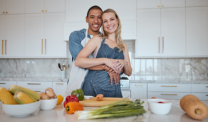 Image showing Portrait, cooking and food with a couple in the kitchen together preparing a meal for lunch or supper in their home. Love, diversity and health with a man and woman making dinner while bonding