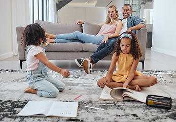 Image showing Learning, education and kids with family in living room studying. Home school, diversity and girls reading books, writing or drawing with mother and father on sofa supporting development in house.