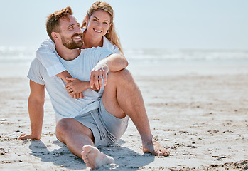 Image showing Love, hug and couple on beach holiday, vacation or summer trip outdoors. Portrait, care and happy man and woman embrace, cuddle and hugging while enjoying quality time together on sandy seashore.