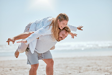 Image showing Couple, happy and beach holiday with travel, fun and playful together, anniversary vacation by the ocean with freedom and comedy. Happiness, man with woman and laugh, love and piggyback on Bali coast