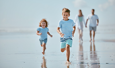 Image showing Children, running and beach with a brother and sister together on the sand by the sea or ocean during summer. Family, travel and fun with sibling kids on the coast with their parents for holiday