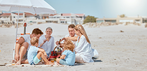 Image showing Beach, umbrella and happy family relax on vacation, summer travel and tropical holiday in sunshine. Big family, ocean and sea sand for calm, peace and love, care and quality time together on picnic