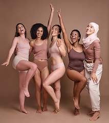 Image showing Beauty, women and celebrate diversity portrait in underwear with modest muslim woman for skincare campaign. Inclusion, happiness and body care model group with girl in hijab in brown studio.