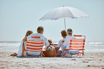 Image showing Beach, umbrella and big family on a summer vacation, trip or seaside journey together in Australia. Travel, relax and children on a holiday adventure with their grandparents and parents by the ocean.