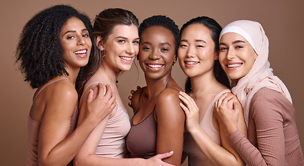 Image showing Skincare, diversity and women hug portrait for inclusivity, happiness and healthy skin texture. Interracial beauty and model group with woman in hijab smile for cosmetic campaign in brown studio