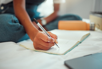 Image showing Notebook, bed and hands of student writing homework, research project or journal entry while in home bedroom. Planner, education and woman planning schedule for university study or college learning