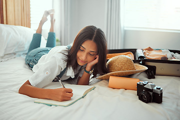 Image showing Writing, notebook and travel with woman and suitcase for planning, checklist or schedule vacation. Summer, adventure and photographer with girl and luggage in bedroom for journey, packing and holiday