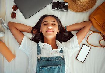 Image showing Top view, relax and woman sleeping on bed at hotel on vacation, holiday or trip. Phone mockup, travel dream and happy female in bedroom at motel, resort or lodge with camera, laptop and headphones