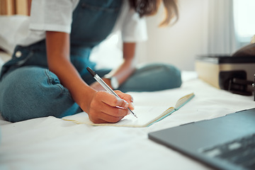 Image showing Hand, writing and notebook with a woman on a bed in her home while blogging, studying or doing research. Bedroom, relax and laptop with a female student holding a pen during a search or planning