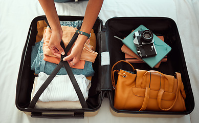 Image showing Travel suitcase, bedroom and hands of woman packing for Europe holiday, vacation or adventure tourist journey. Hospitality, hotel bed and photographer with luggage bag, clothes and camera in Madrid