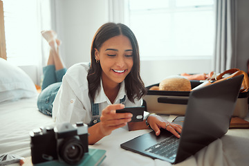 Image showing Ecommerce, travel and credit card of a woman packing suitcase with computer booking flight in hotel. Internet, online shopping and digital banking of a person on a bed ready for a vacation discount