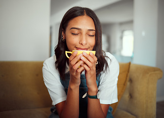 Image showing Coffee, woman and morning drink on a home living room sofa feeling calm, relax and peace. House, tea and natural aroma of a person smelling and relaxing in a house with gratitude and happiness