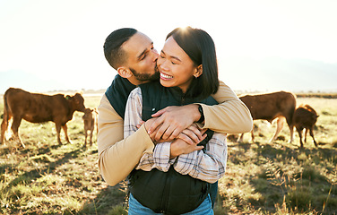 Image showing Love, cow and agriculture with couple on farm for bonding, kiss or affectionate hug. Sustainability, production and cattle farmer with man and woman in countryside field for dairy, livestock or relax