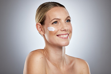 Image showing Beauty, skincare and lotion on face of woman for facial, sunscreen or self care routine with cream. Cosmetics, product and luxury with model for moisturizing, anti aging and spa cosmetology in studio