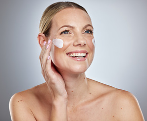 Image showing Skincare, cream and beauty woman in studio with cosmetics, makeup and product promotion, marketing and advertising. Happy skin care model, facial cleaning or sunscreen for dermatology glow and shine