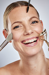 Image showing Beauty, portrait or woman with a brush for makeup, roller and eyeliner for facial skincare grooming routine in studio. Wellness, face or happy girl model smiles with self care cosmetics product tools