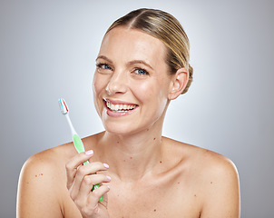 Image showing Face, teeth and woman with toothbrush in studio isolated on a gray background. Oral health, dental veneers and female model getting ready to brush with toothpaste for hygiene, cleaning and wellness.
