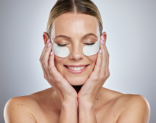 Image showing Woman, eyes mask and skincare portrait with hands in studio for beauty wellness, luxury facial care or cosmetics dermatology. Happy Australian girl, face skin hydration and anti aging eye patches