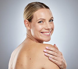 Image showing Portrait, beauty and skincare with a model woman touching her back in studio on a gray background. Health, wellness and cosmetics with an attractive young female posing to promote skin care