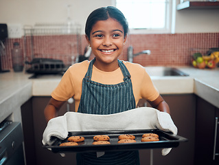 Image showing Baking, cookies and children with an indian girl cooking baked goods in the kitchen of her home alone. Food, kids and apron with a female child learning how to bake in her house in the morning