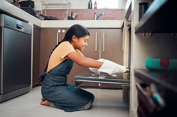 Image showing Cooking, oven and girl child in kitchen holding tray after baking in home. Learning, education and happy kid teaching herself how to bake pastry, having fun and enjoying quality time alone in house.