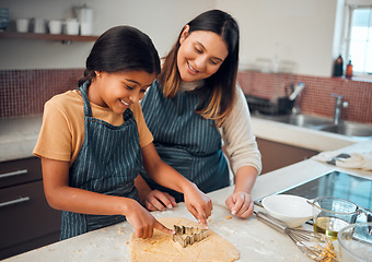 Image showing Mother, girl and kitchen for teaching, cookies and learning for baking, bonding and love in family home. Woman, daughter and cooking for festive food, holiday or celebration for christmas in house