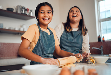 Image showing Happy family, mother and girl baking a cake, cookies or muffin in a kitchen laughing at home. Eggs, funny mom and young child holding a rolling pin for flour, wheat or dough learning cooking skills