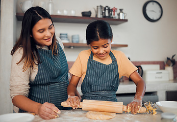 Image showing Family, mother and girl baker with a pin rolling dough helping baking a cake, food or cookies in a house kitchen. Child development, learning or happy mom teaching a young Indian kid cooking skills