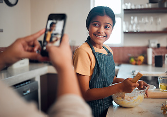 Image showing Baking, girl and phone picture of a child cooking in home kitchen with a proud smile about learning. Happy, cooking development and kid in a house helping to make cookies with mom and mobile photo