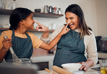 Image showing Mother, girl and cooking while playing with flour, having fun or bonding. Learning, education and happy child chef with caring mom baking pastry, smiling and enjoying time together with dough on nose